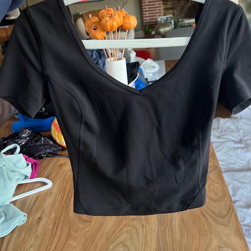 Black athletic top tight fitting with low neck